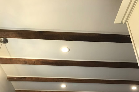 Electrician installing recessed LED lighting in a Holton, KS kitchen